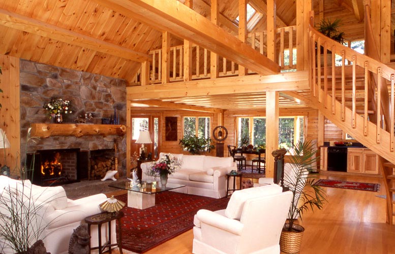Spacious living room with wooden interior and stone fireplace