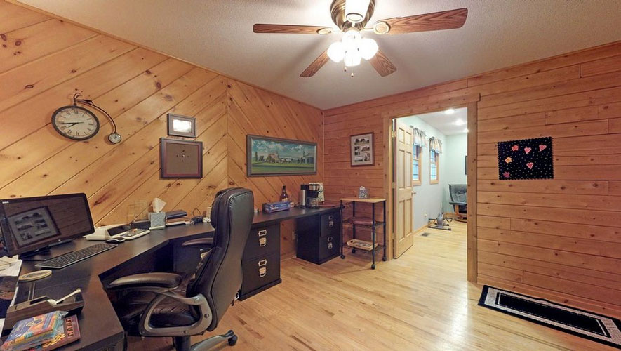 Home office with wooden walls and desk in Princeton plan