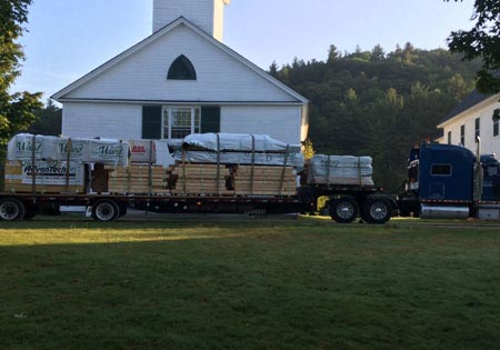 Truck loaded with log home building materials