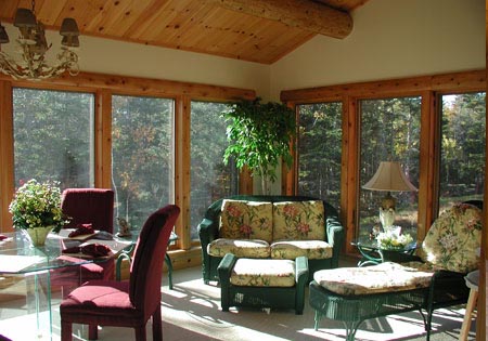 Living room with large windows and wooden ceiling