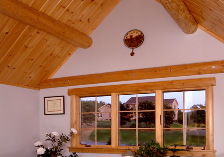 Room with wooden ceiling and large window view