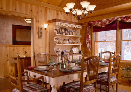 Dining room with wooden table and chairs, chandelier, and hutch