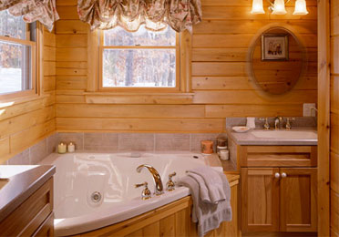 Wood-paneled bathroom with a large bathtub and sink