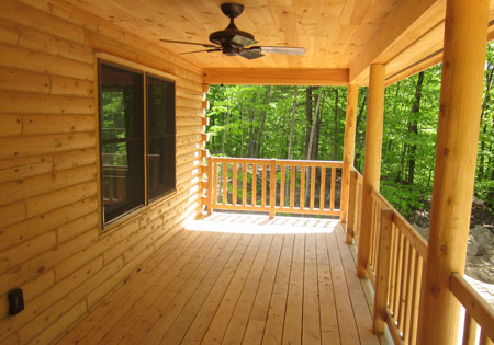 Wooden porch with railing and forest view