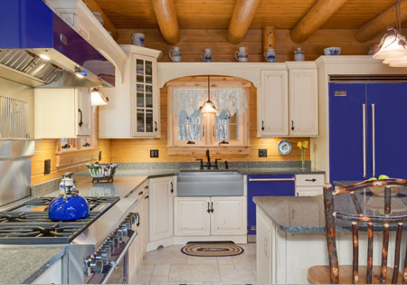 Log cabin kitchen with blue appliances and decor