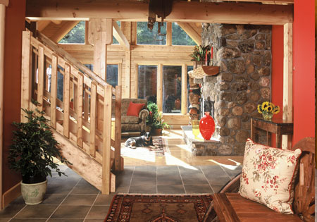 Rustic log home living room with stone fireplace