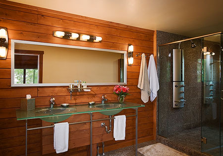 Wood-paneled bathroom with glass shower and vanity