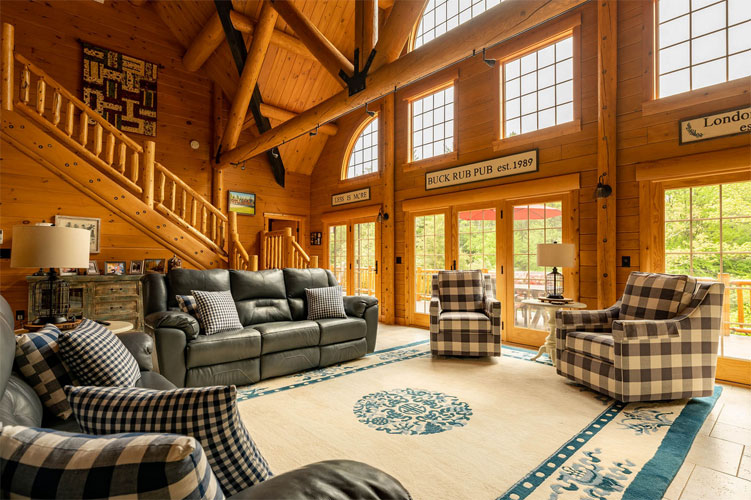 Cozy log home living room with large windows