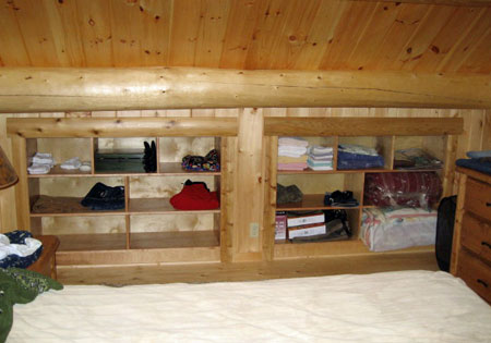 Wooden shelves with clothes and boxes in attic