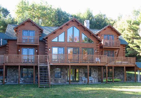 Large cedar log home with walk-out basement and balconies.
