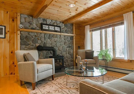 Warm log home living room with stone fireplace
