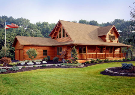 Log home with green lawn and decorative plants