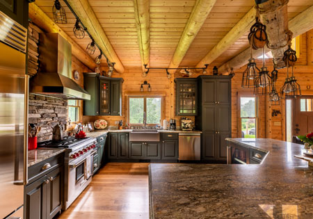 Spacious log home kitchen with wooden beams and island