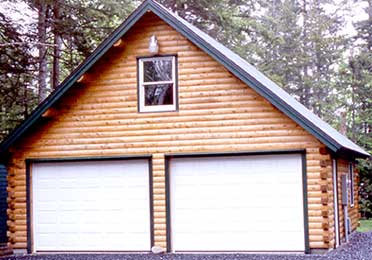 A log garage with two white doors and a window above