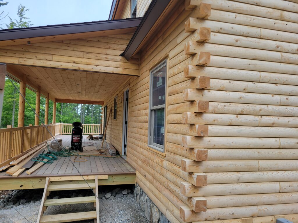 Wooden log home with extended porch and steps