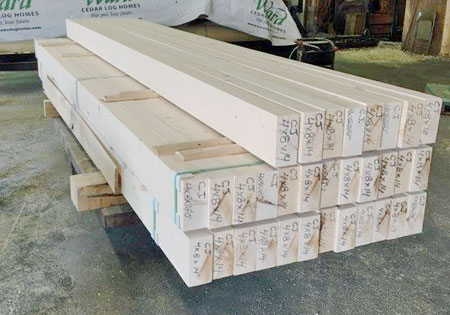 Stack of wooden ceiling joists in a workshop setting