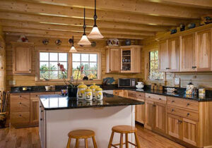 Wooden kitchen with exposed ceiling joists and island.