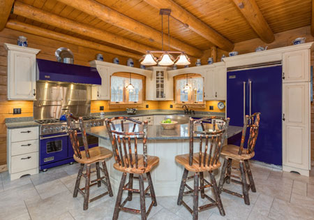 Kitchen with wooden ceiling joists, island, and chairs