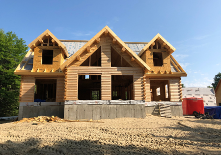 Partially built log home with exposed wooden beams