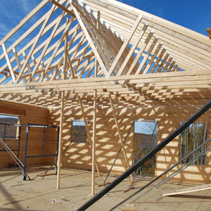 Wooden frame structure of a log home under construction.